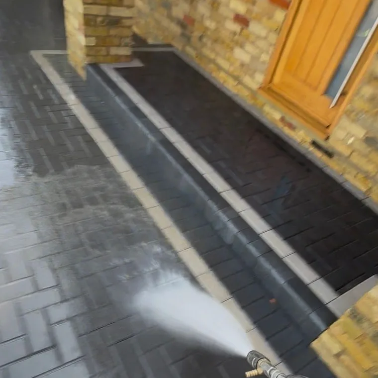 Pressure-washing the block-paved driveway clean